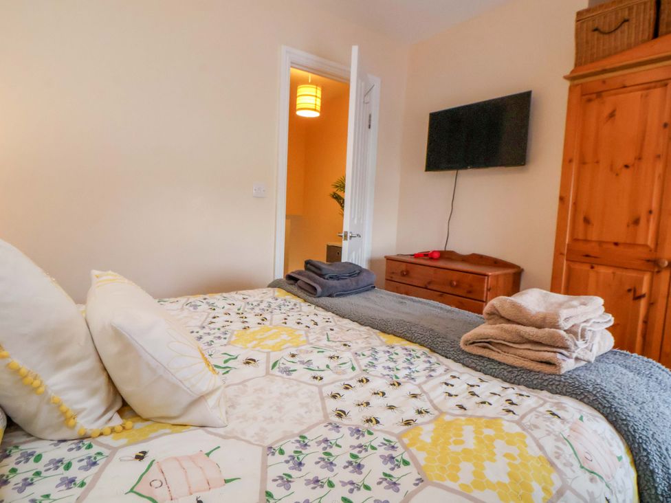 A bedroom with a bed and dresser at Hill View in Bala