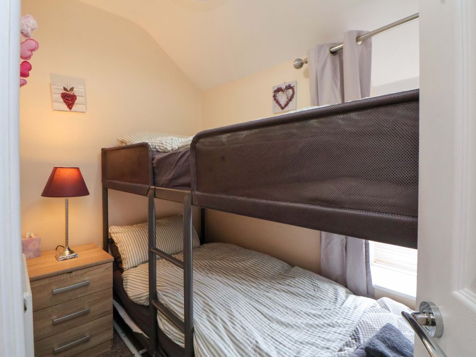 A bedroom with a bunk bed and nightstand at Hill View in Bala