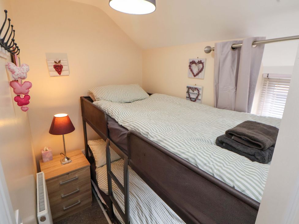 A bedroom with a bunk bed and nightstand at Hill View in Bala
