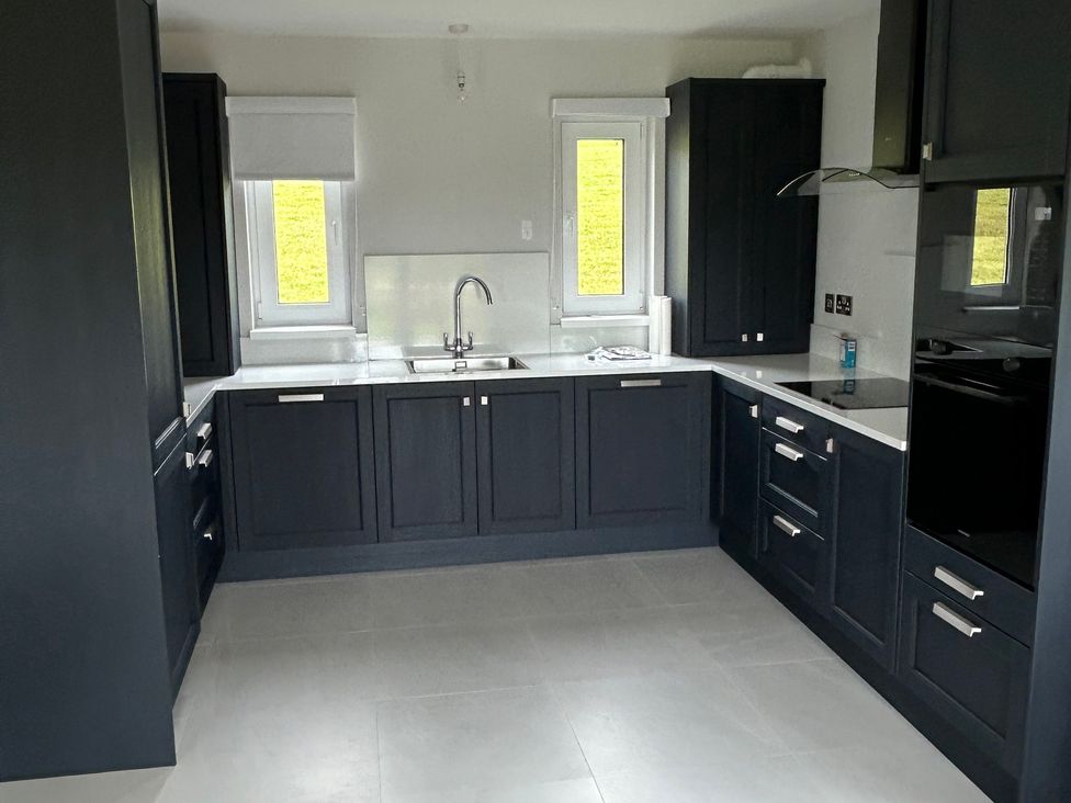 A kitchen with a sink and window at 30 River Run in Belturbet