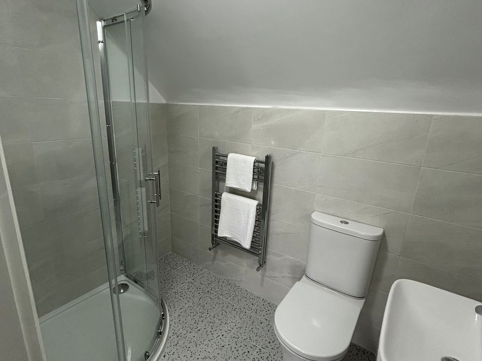 A bathroom with a shower and toilet at 30 River Run in Belturbet