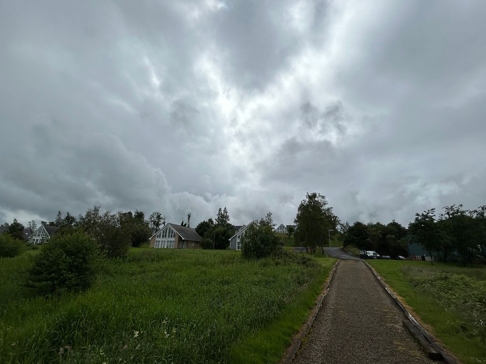 A pathway leading to houses with cloudy sky at 30 River Run in Belturbet