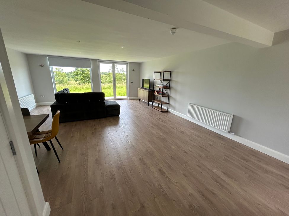 A living room with a sofa and television at 30 River Run in Belturbet, County Cavan