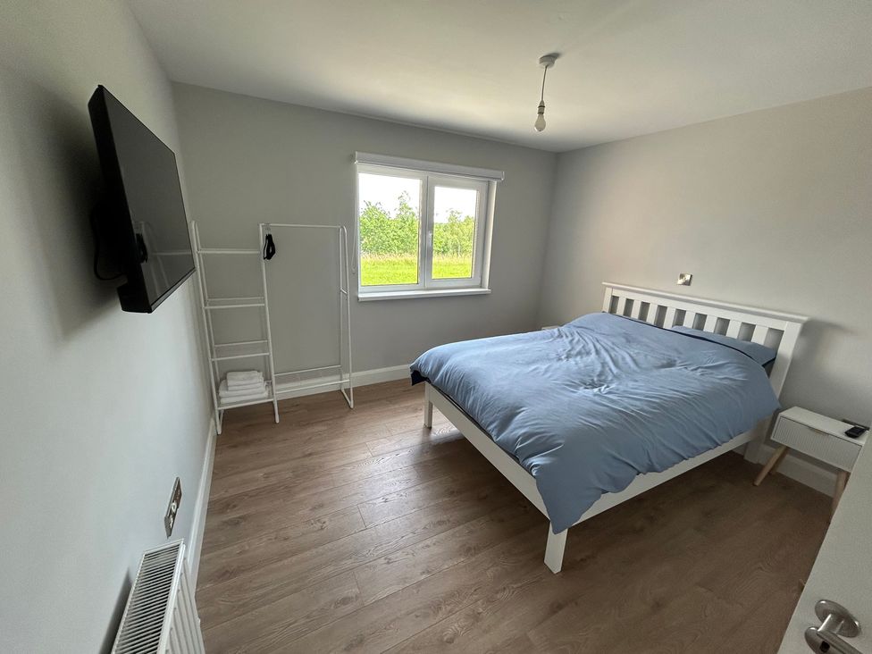 A bedroom with a bed and a television at 30 River Run in Belturbet, County Cavan