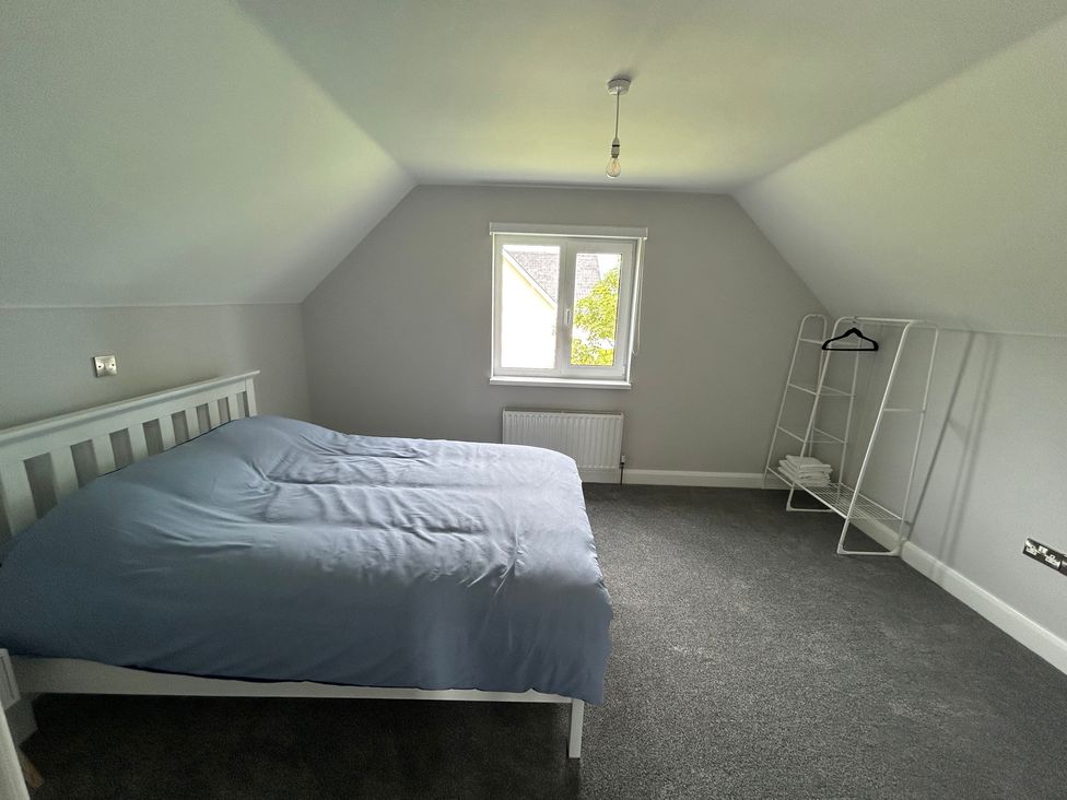 A bedroom with a bed and window at 30 River Run, Belturbet, County Cavan