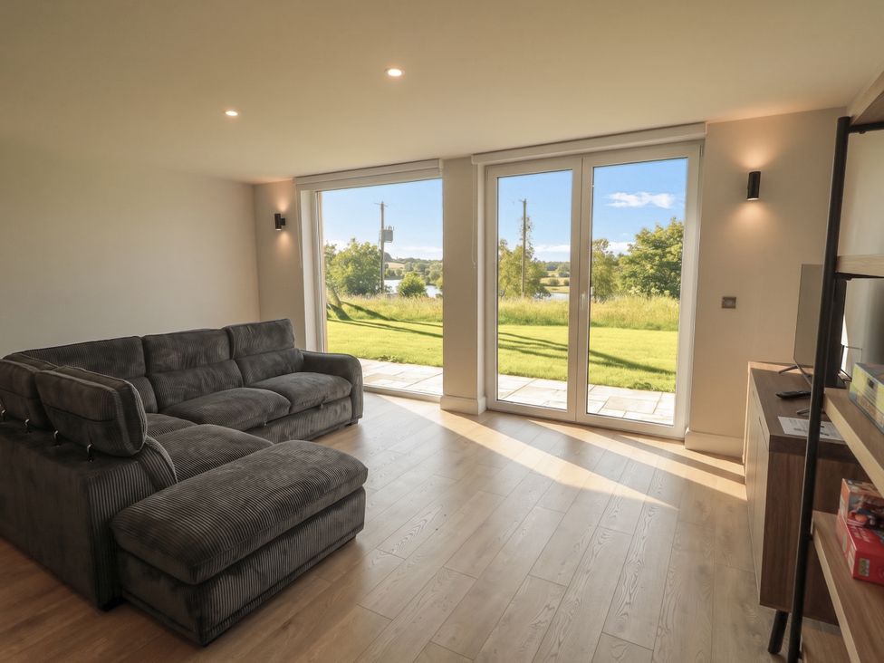 A living room with a sofa and sliding doors at 30 River Run in Belturbet, County Cavan
