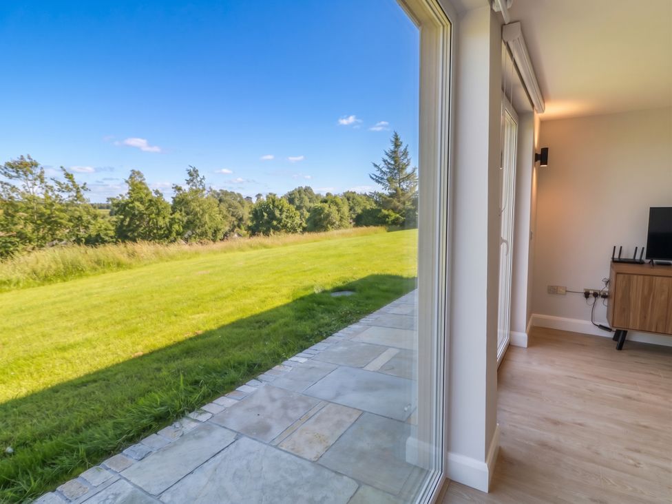 A living room with a view of grass and trees at 30 River Run in Belturbet, County Cavan