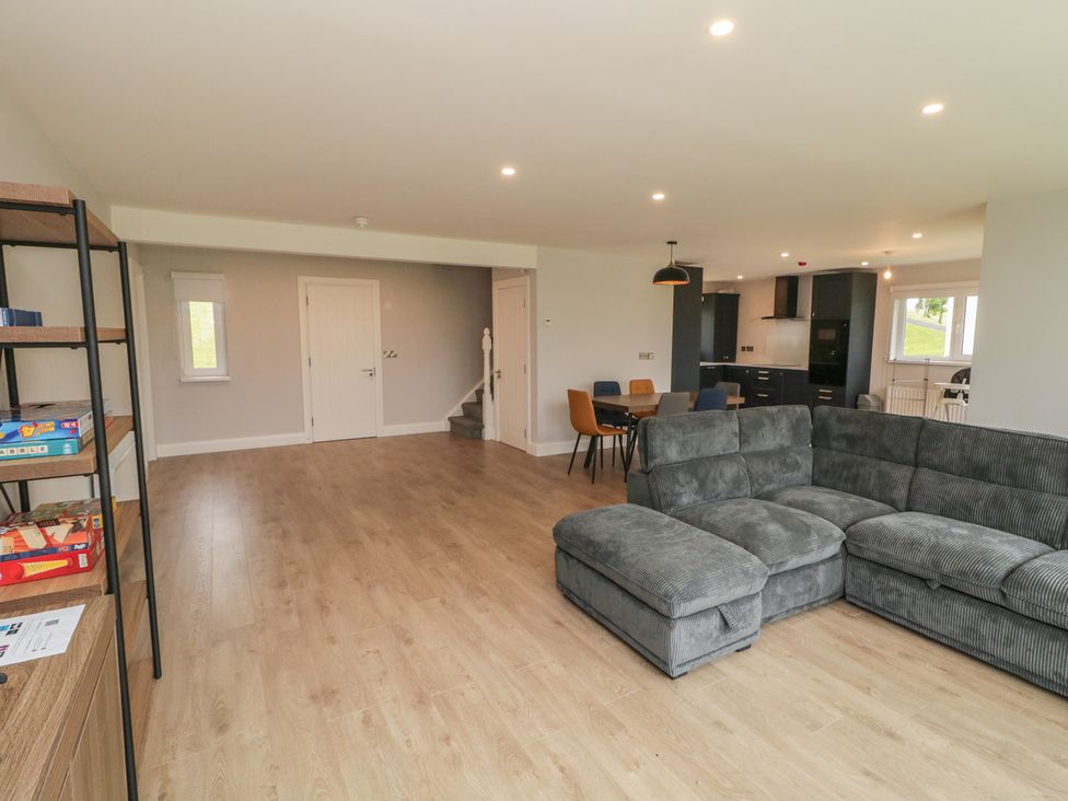A living room with a couch and dining table at 30 River Run in Belturbet, County Cavan