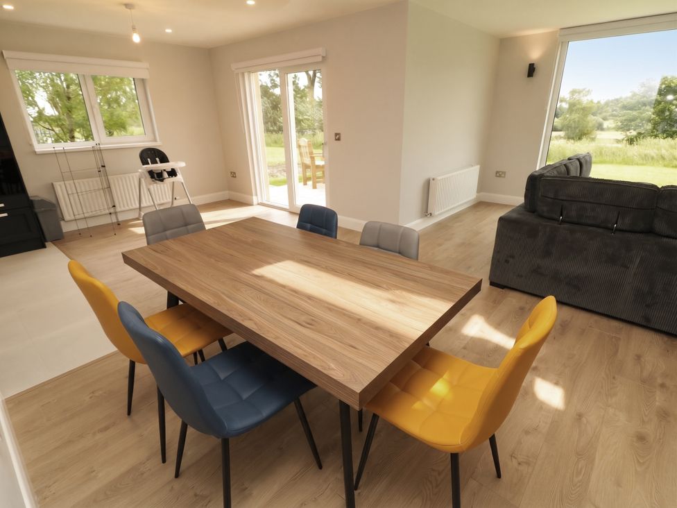 A dining room with a table and chairs at 30 River Run Belturbet, County Cavan