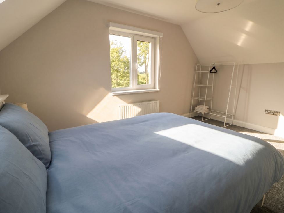A bedroom with a bed and shelves at 30 River Run, Belturbet, County Cavan