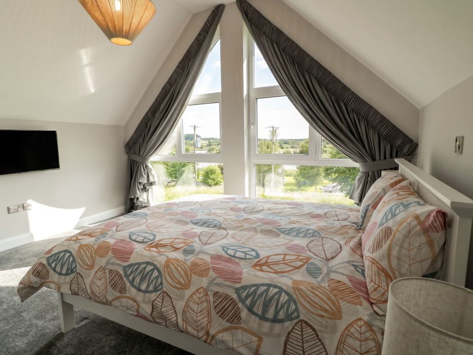 A bedroom with a bed and tv at 30 River Run in Belturbet, County Cavan
