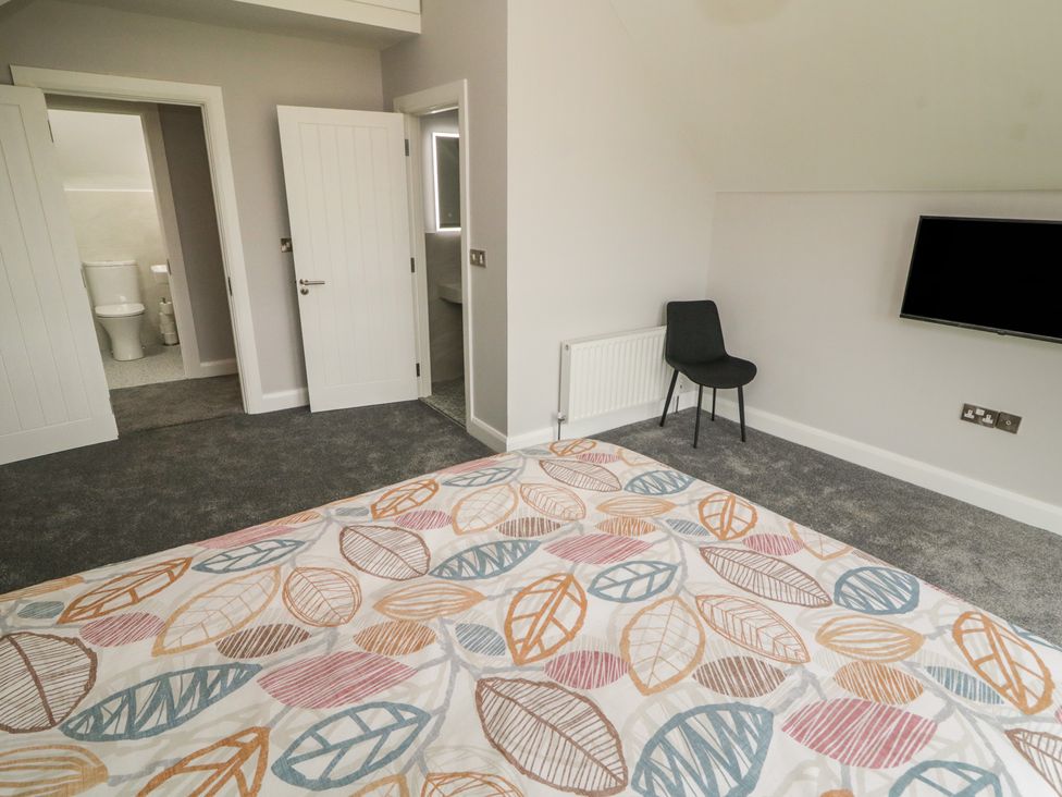 A bedroom with a bed and a chair at 30 River Run, Belturbet, County Cavan