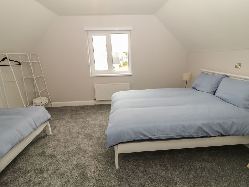 A bedroom with two beds and a window at 30 River Run, Belturbet, County Cavan