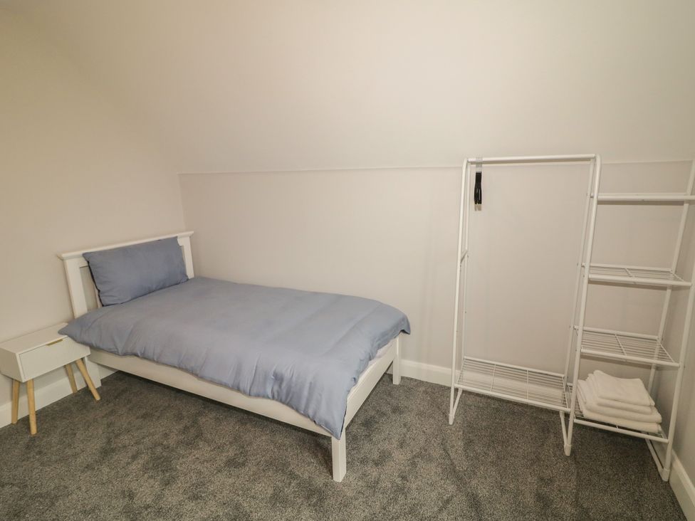 A bedroom with a bed and storage racks at 30 River Run Belturbet, County Cavan