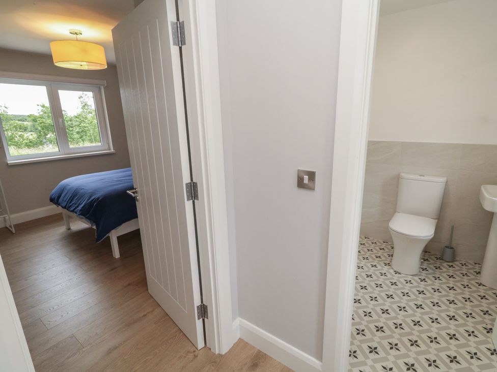 A bathroom with toilet and sink at 30 River Run, Belturbet, County Cavan