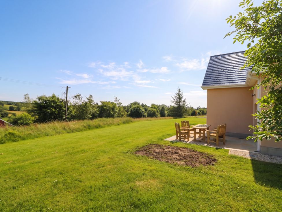 An outdoor area with a table and chairs at 30 River Run in Belturbet, County Cavan