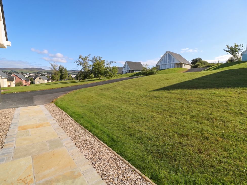 An outdoor area with a pathway leading to houses at 30 River Run, Belturbet, County Cavan