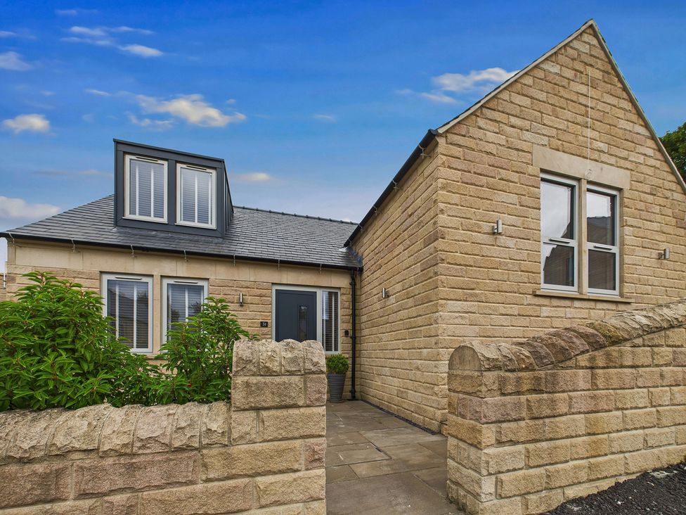 A house with a pathway and garden at Oakwood Lodge in Tansley
