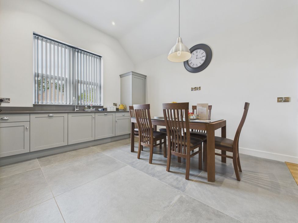 A kitchen with a dining table and chairs at Oakwood Lodge in Tansley