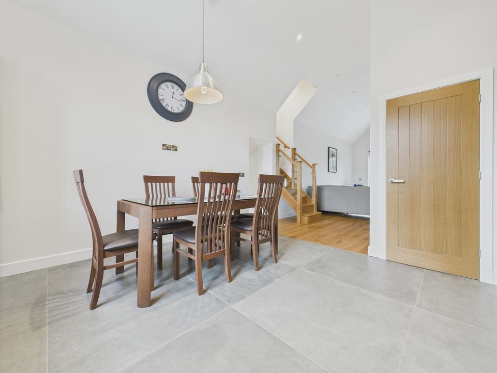 A dining area with a table and chairs at Oakwood Lodge in Tansley