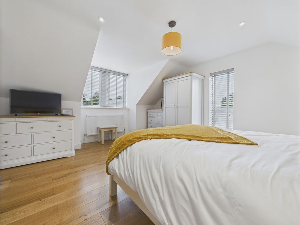 A bedroom with a bed and a dresser at Oakwood Lodge Tansley