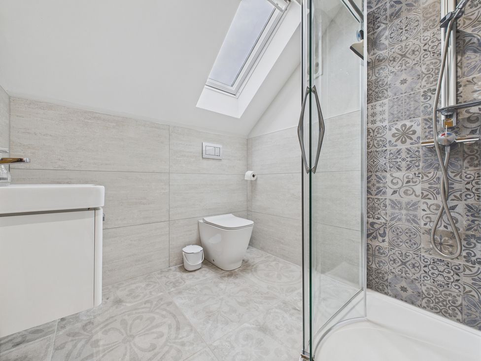 A bathroom with a shower and toilet at Oakwood Lodge in Tansley