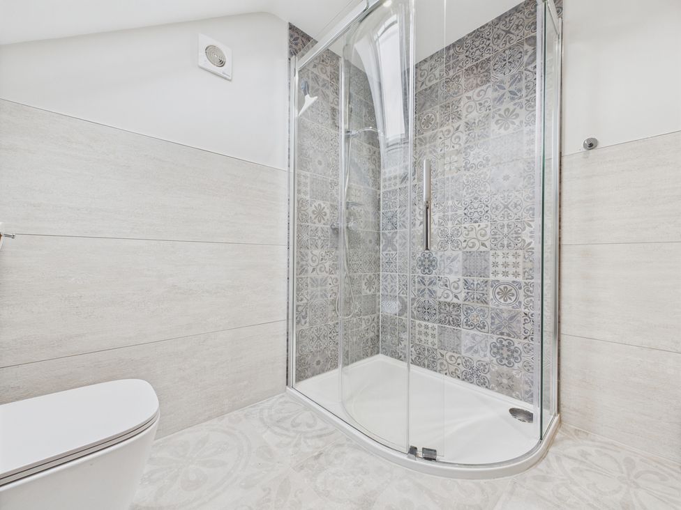 A bathroom with a shower and toilet at Oakwood Lodge in Tansley