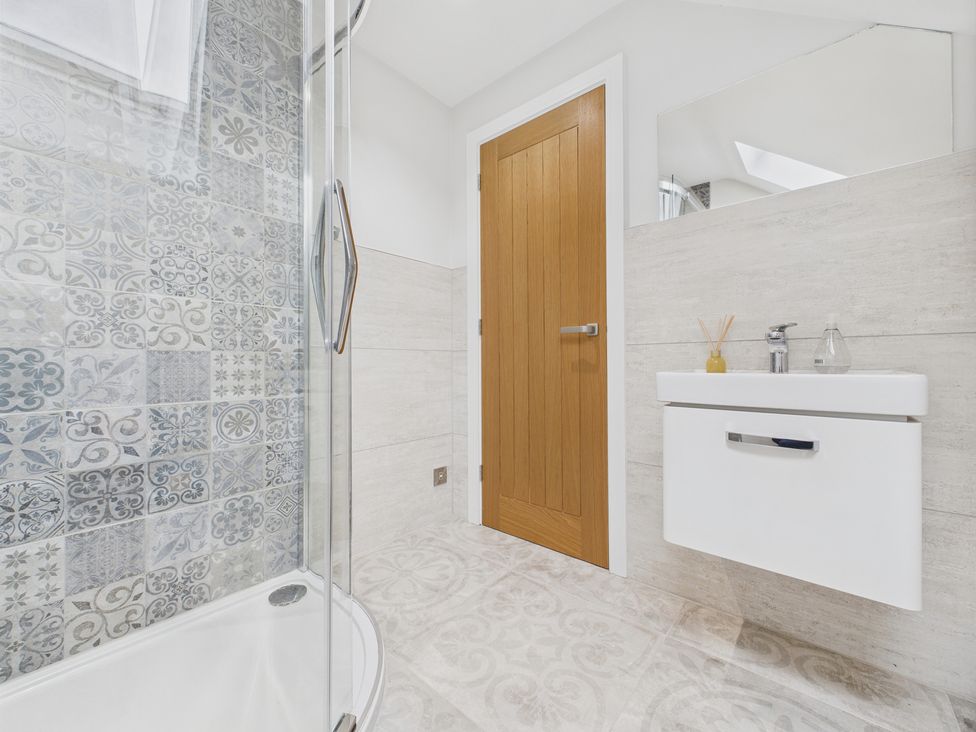 A bathroom with a shower and sink at Oakwood Lodge in Tansley