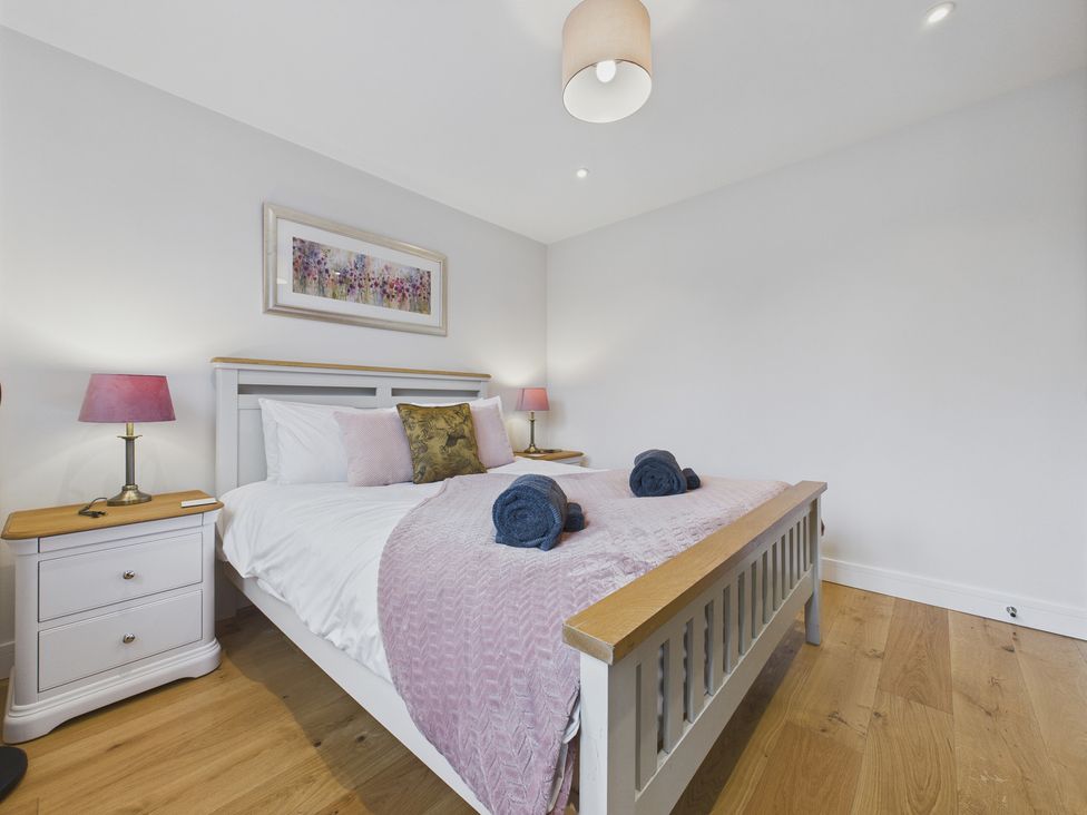 A bedroom with a bed and bedside tables at Oakwood Lodge in Tansley