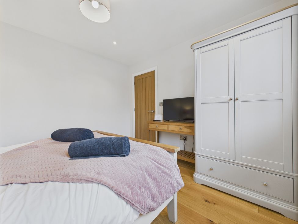 A bedroom with a bed and a television at Oakwood Lodge in Tansley