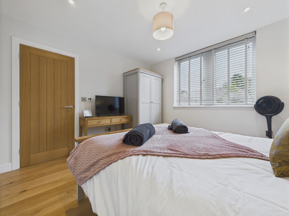 A bedroom with a bed and television at Oakwood Lodge in Tansley