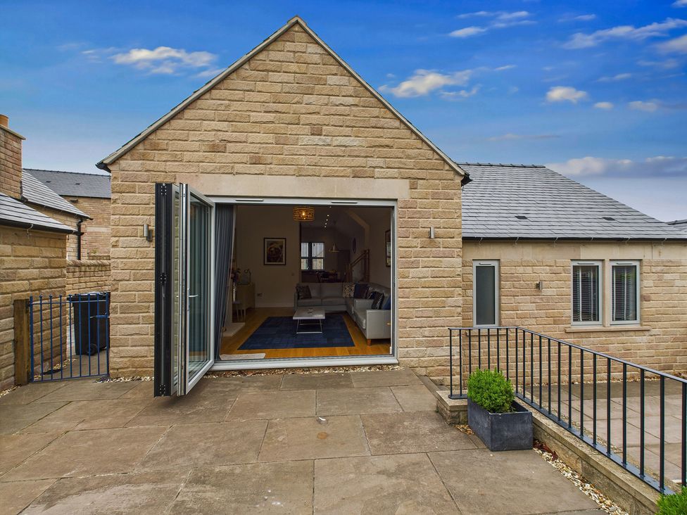 An outdoor area with an open doorway leading inside at Oakwood Lodge in Tansley