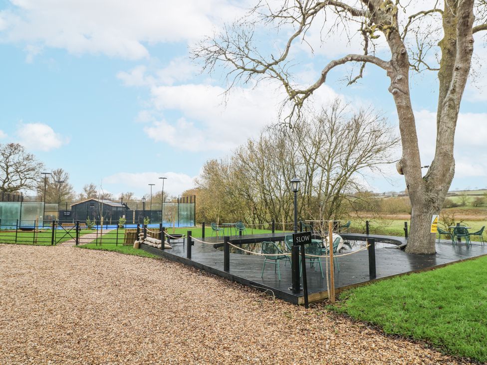 An outdoor area with seating and trees at Otter's View in South Luffenham near Edith Weston