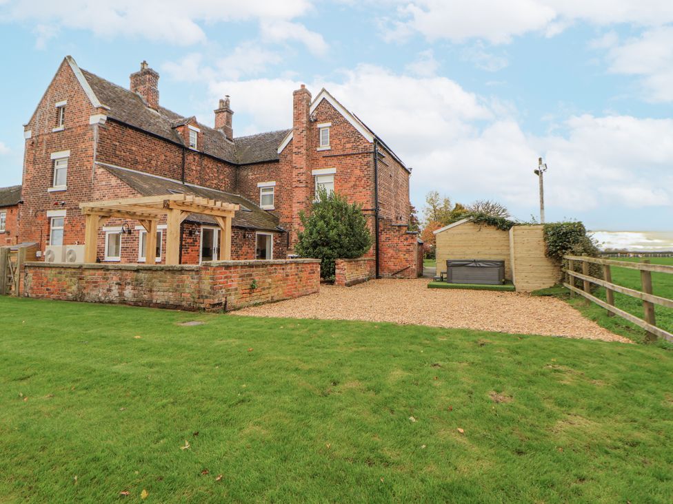 A house with a pergola and garden area at The House at School Farm in Hassall near Haslington