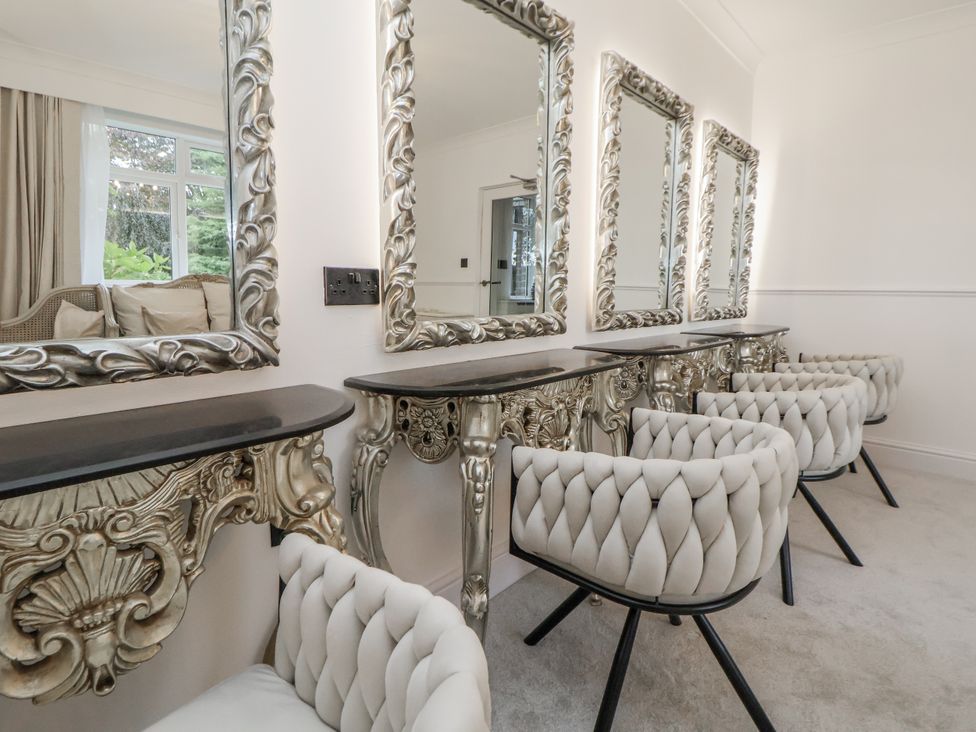 A dressing room with mirrors and chairs at The House at School Farm in Hassall near Haslington