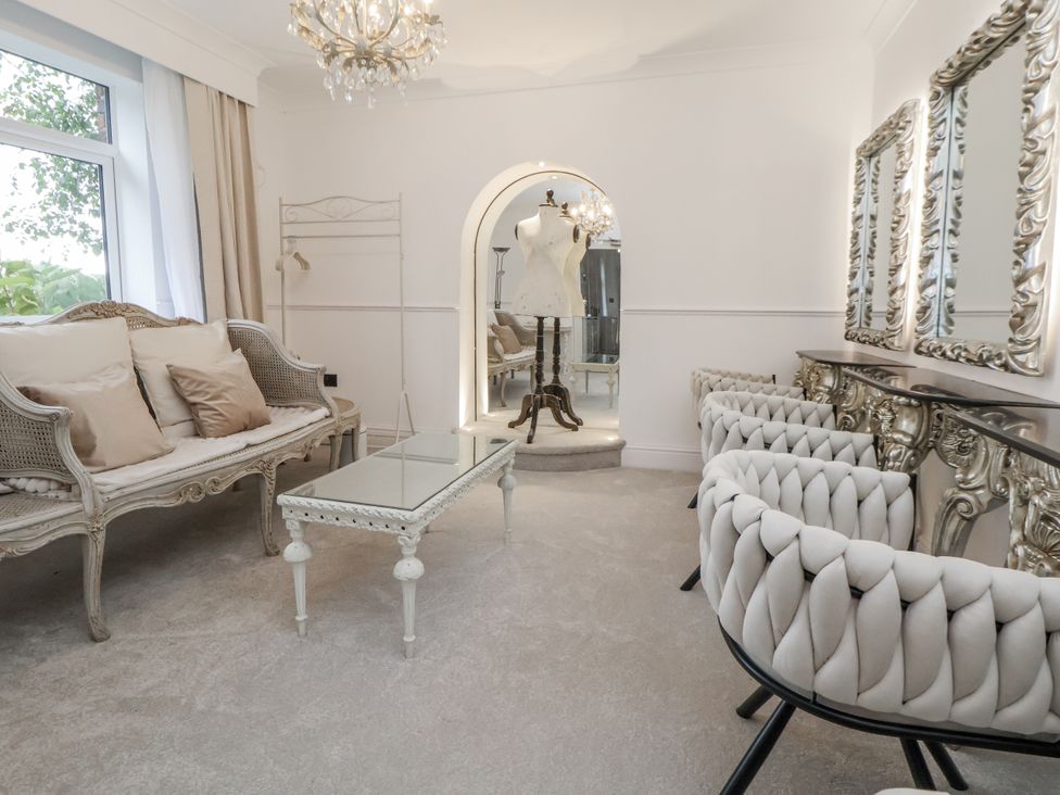 A sitting room with a coffee table and armchairs at The House at School Farm in Hassall near Haslington