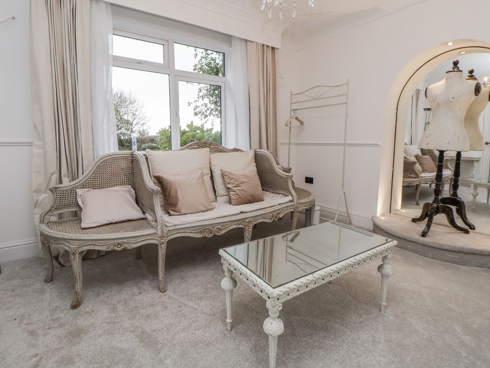 A sitting room with a sofa and coffee table at The House at School Farm in Hassall near Haslington