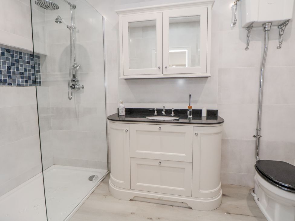A bathroom with a shower, sink, and toilet at The House at School Farm in Hassall near Haslington