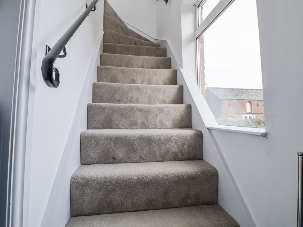 Stairs leading to upper level at The House at School Farm in Hassall near Haslington