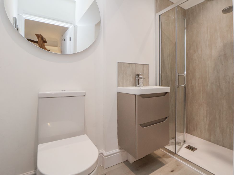 A bathroom with a toilet, sink, and shower at The House at School Farm in Hassall near Haslington