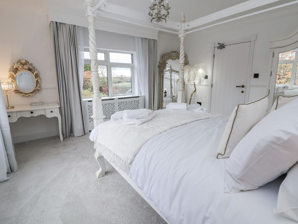 A bedroom with a bed and dressing table at The House at School Farm in Hassall near Haslington