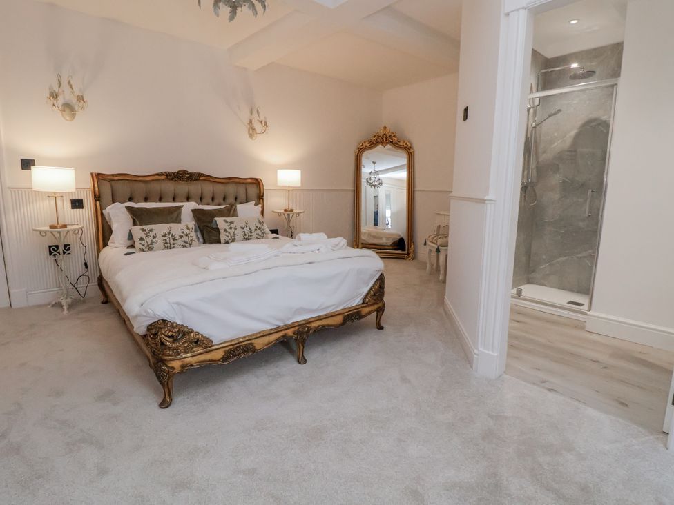 A bedroom with a bed and a shower area at The House at School Farm in Hassall near Haslington