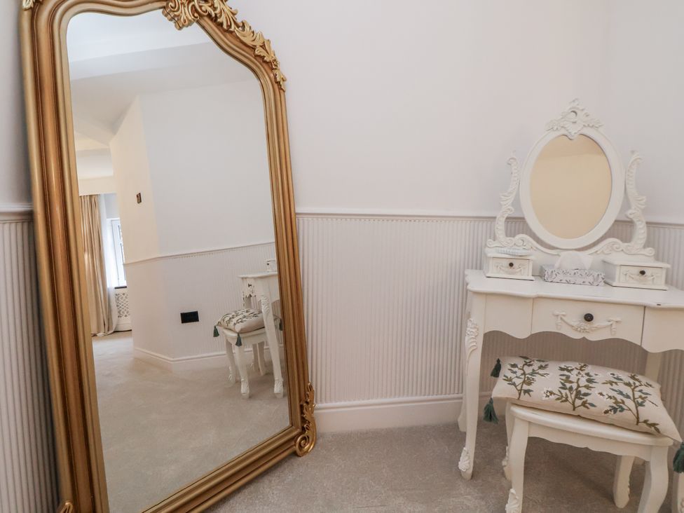 A bedroom with a vanity table and a large mirror at The House at School Farm in Hassall near Haslington