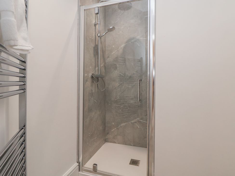 A shower enclosure with a towel rail at The House at School Farm in Hassall near Haslington