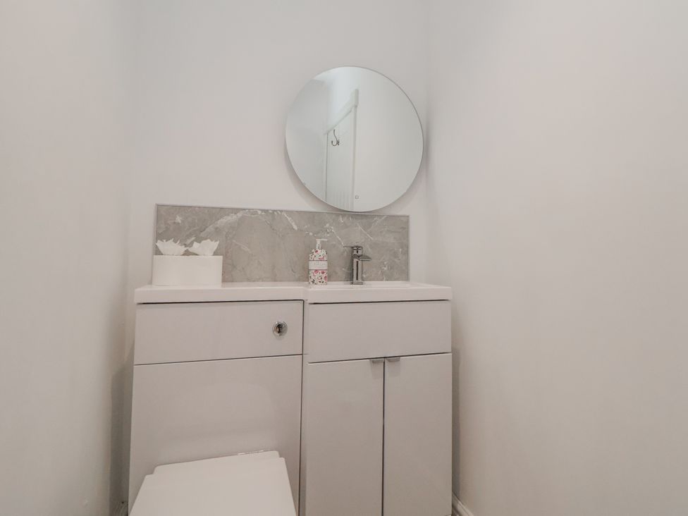 A bathroom with a sink and toilet at The House at School Farm in Hassall near Haslington
