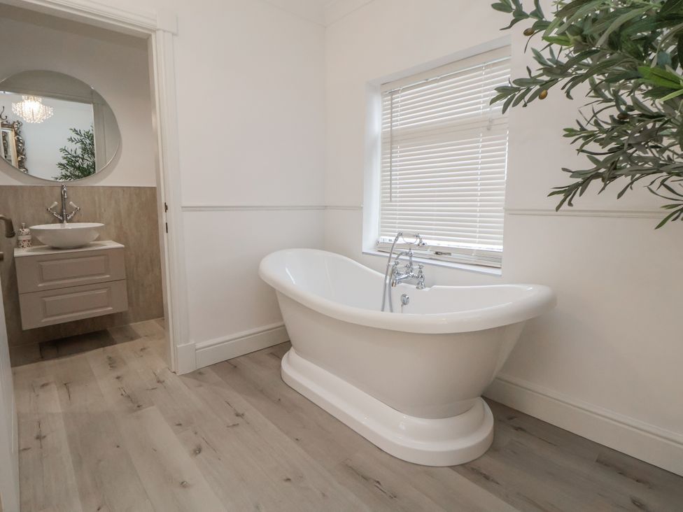 A bathroom with a bathtub and sink at The House at School Farm in Hassall near Haslington