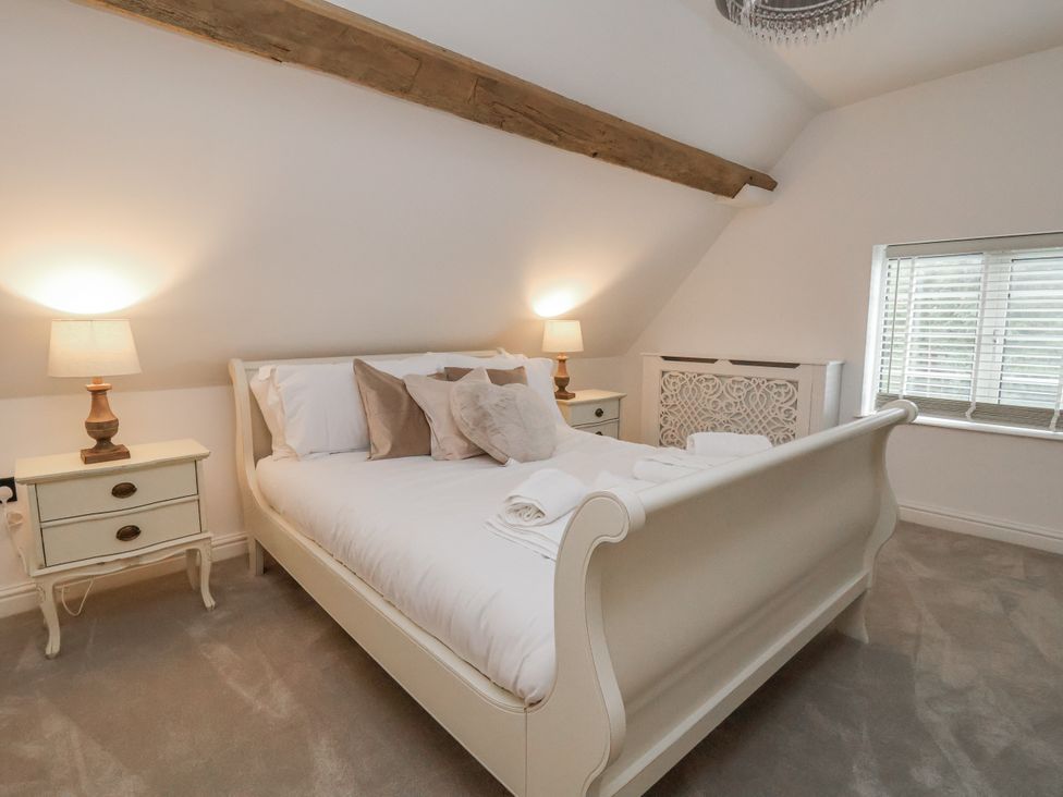 A bedroom with a bed and bedside table at The House at School Farm in Hassall near Haslington