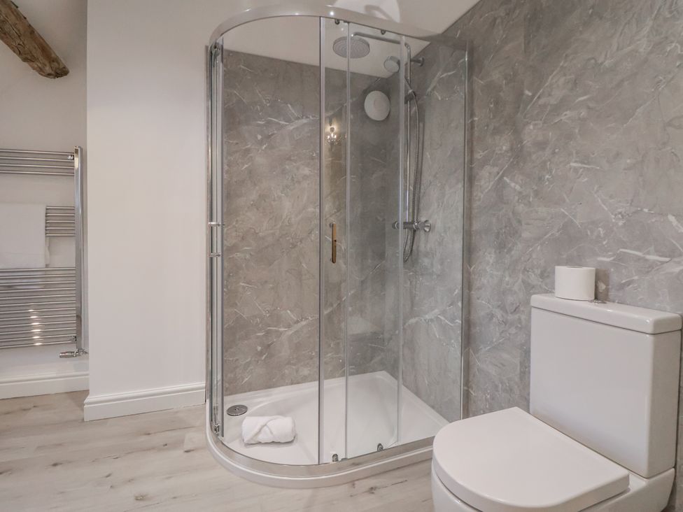 A bathroom with a shower and toilet at The House at School Farm in Hassall near Haslington