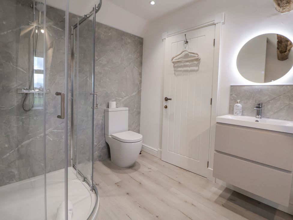 A bathroom with a shower, toilet, and sink at The House at School Farm in Hassall near Haslington