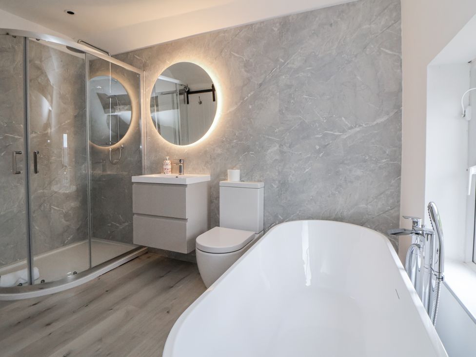 A bathroom featuring a shower, bathtub, sink, and toilet at The House at School Farm in Hassall near Haslington